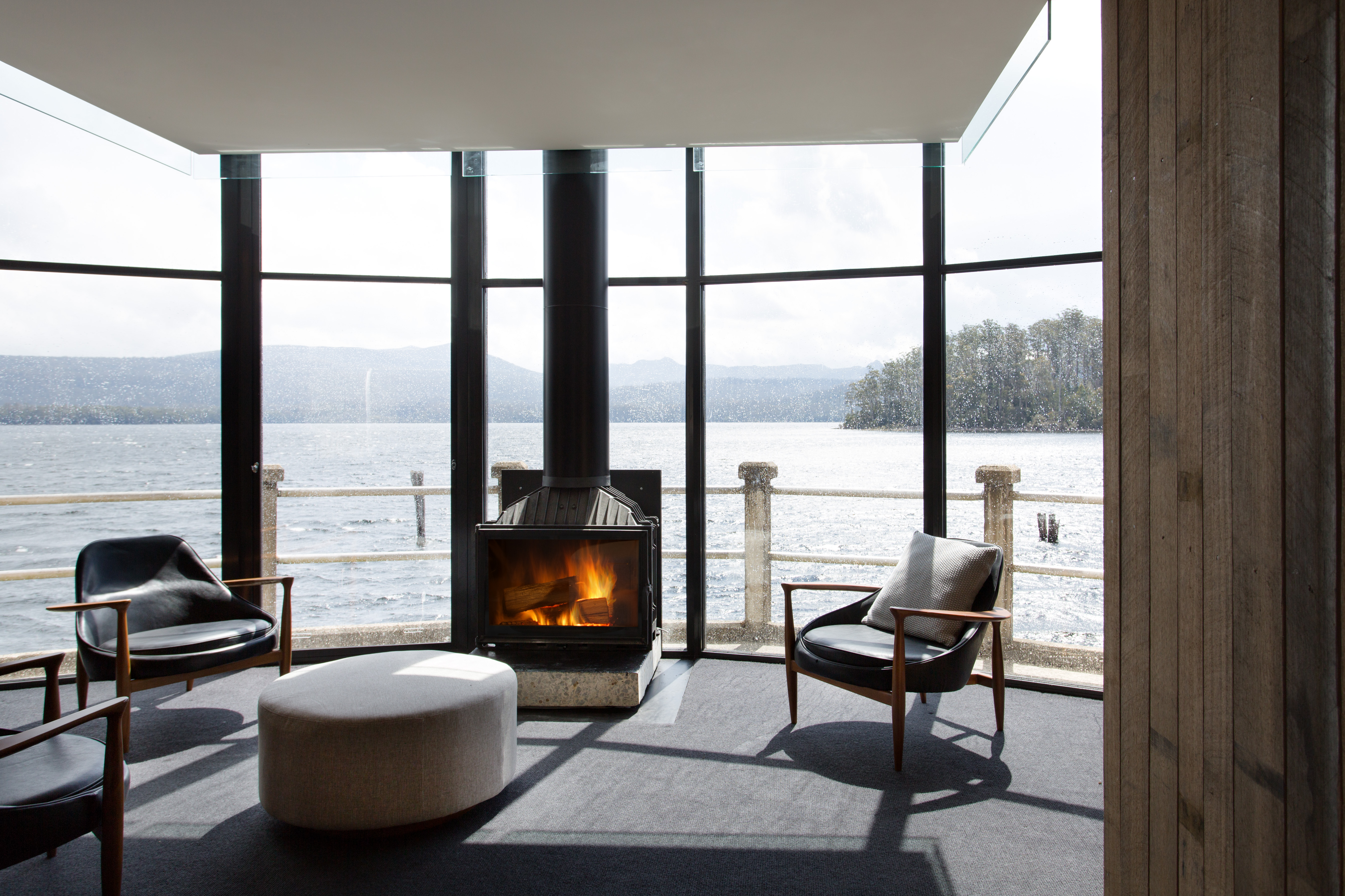 Cozy up by the fireplace with a drink and enjoy views of Australia's deepest lake.